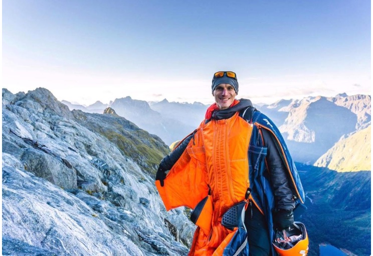 Tristan Webb in his wingsuit on a mountain ridge